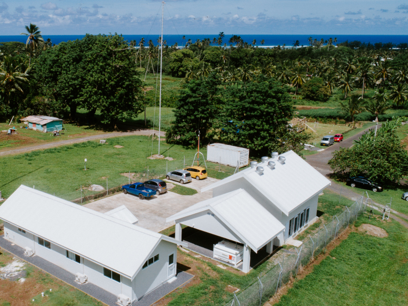 Aerial view of Avaroa House, the ACL office and cable landing station at Aroa, Rarotonga, with the lagoon and reef beyond